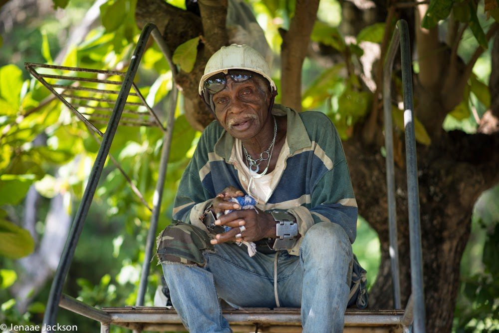 Old man takes a break from work under a tree in Ocho Rios, Jamaica.