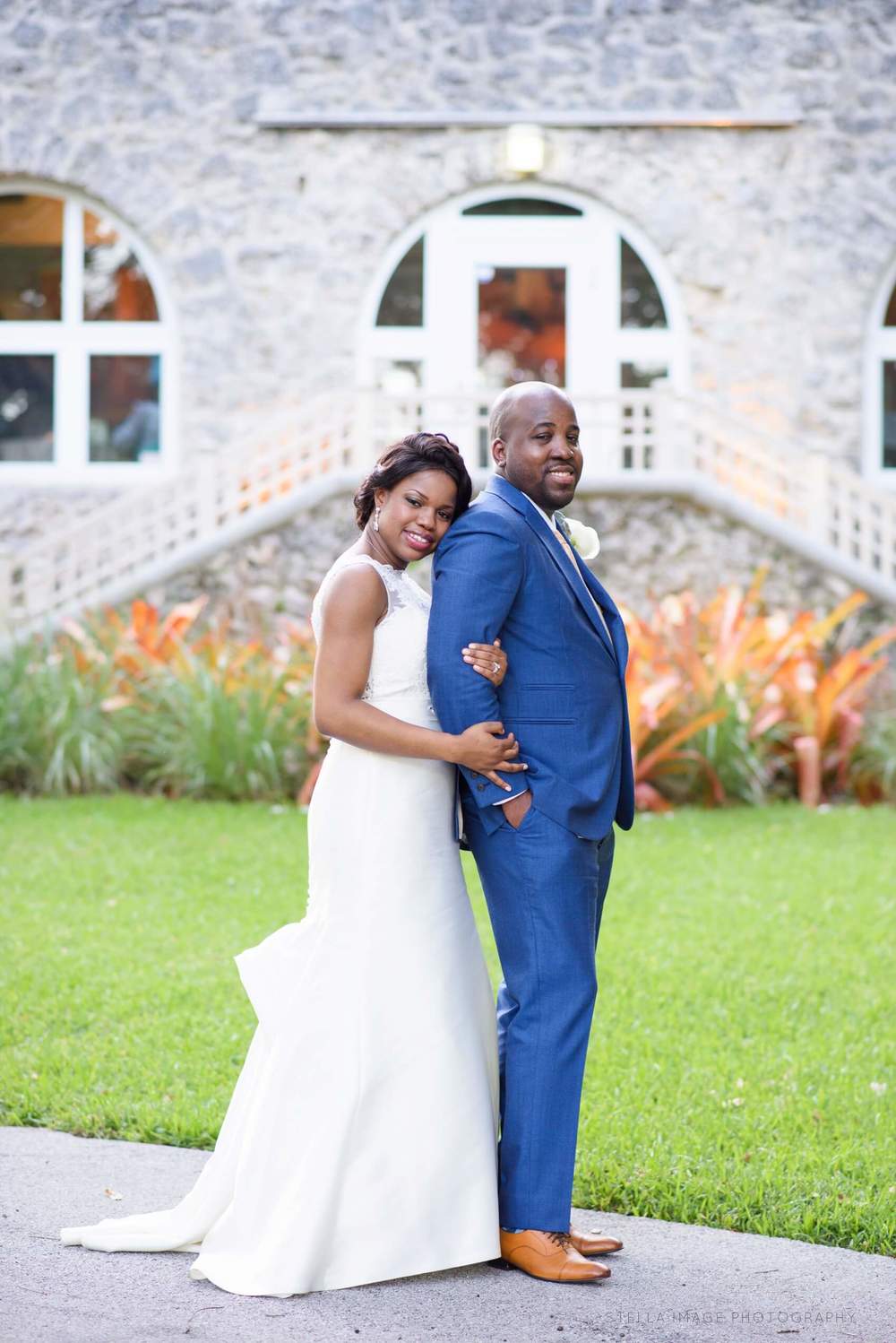 Bride Oluchi holds arm of Groom Marvin in front of the Woman's Club of Coconut Grove.