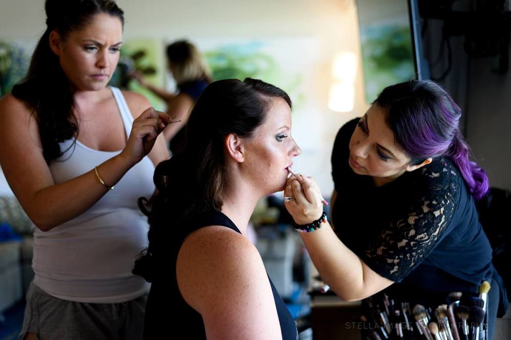 Bride gets her hair and make up done.