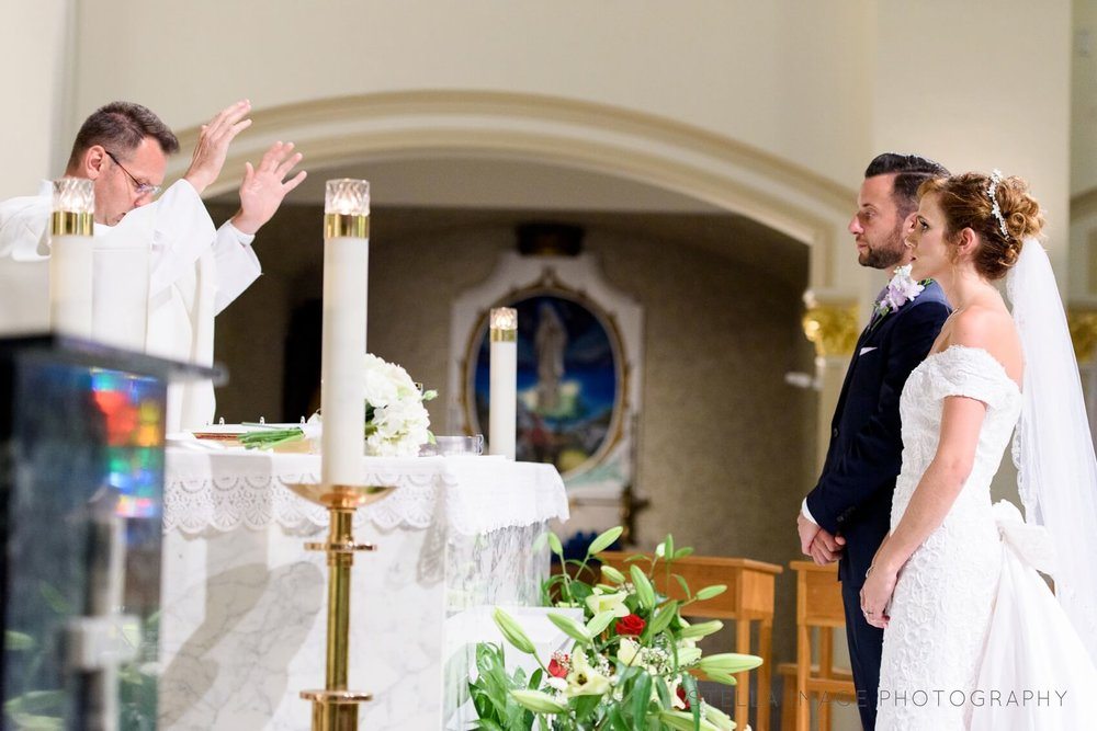 Priest blesses couple.