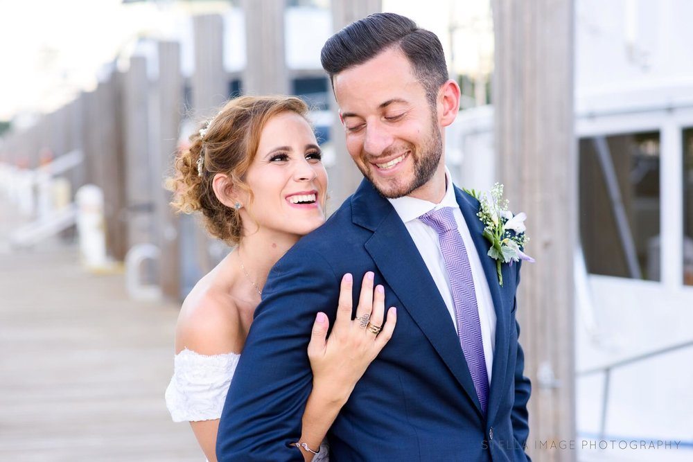 Bride smiling at groom on the dock at the Lauderdale Yacht Club.