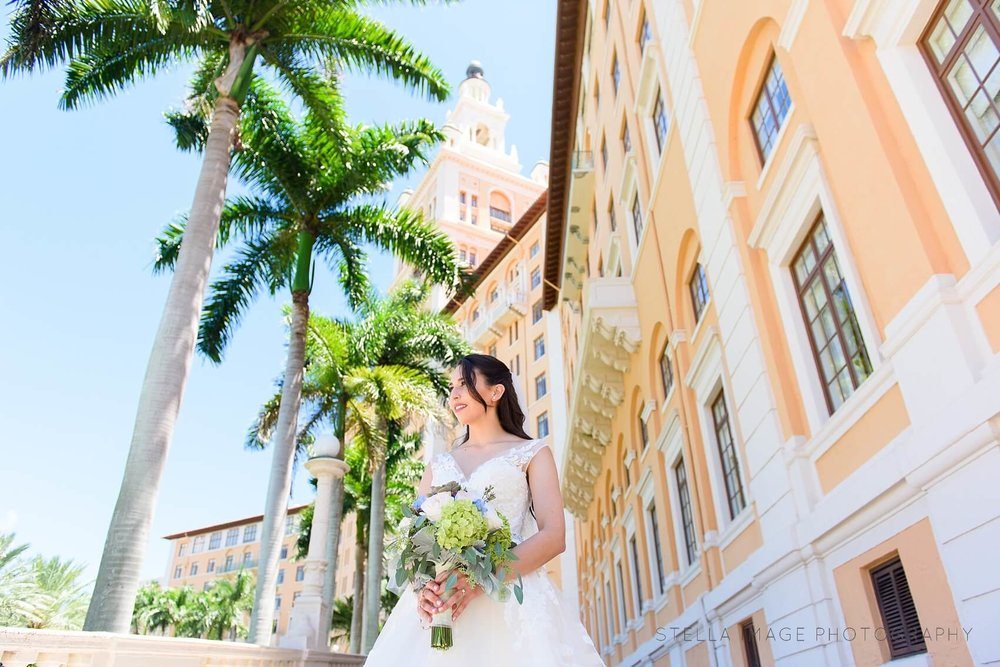 Bride poses at the front Entrance of The Biltmore Hotel Miami